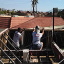 Working on pigeon proofing a gas station canopy